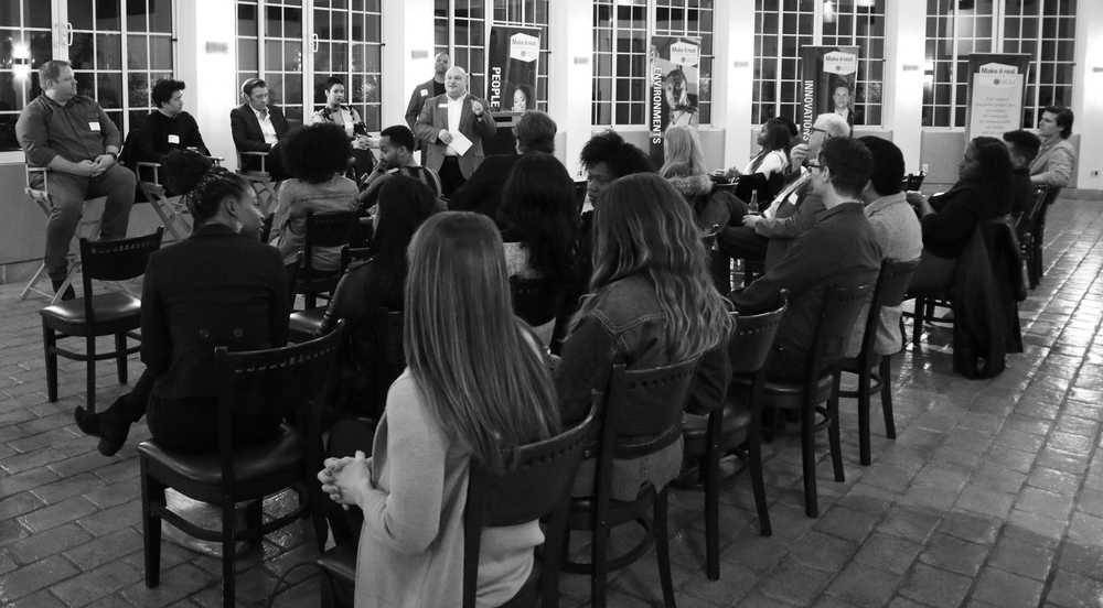 A black and white photo of a crowd at a speaking event.